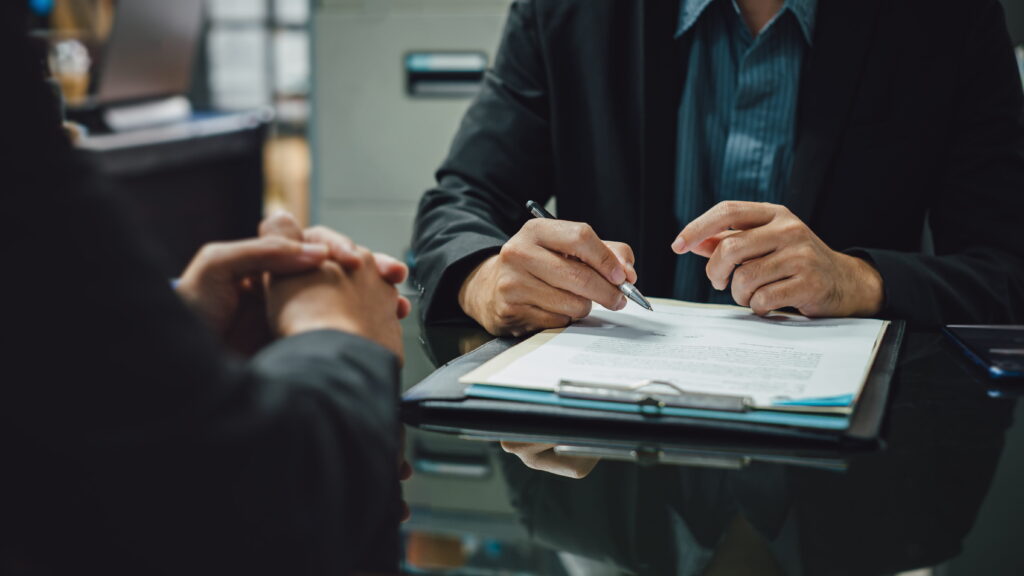 Person reviewing bail bond agreement with bail agent before signing Vista bail bonds contract