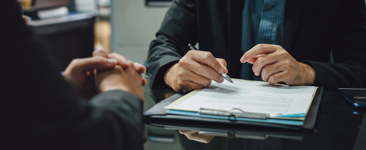 Person reviewing bail bond agreement with bail agent before signing Vista bail bonds contract