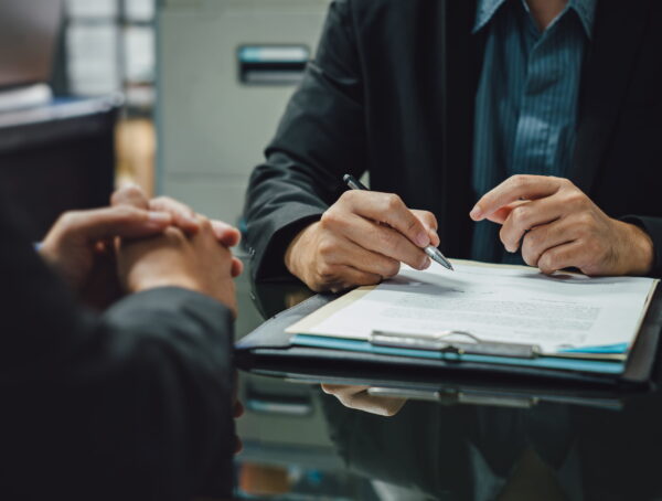 Person reviewing bail bond agreement with bail agent before signing Vista bail bonds contract