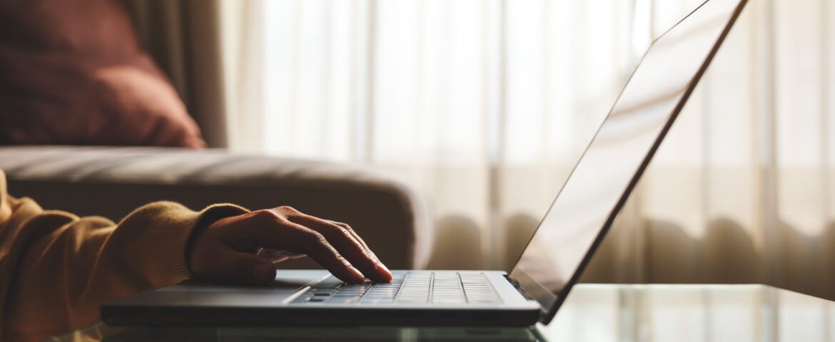 Person completing an online San Diego bail bonds application on a laptop from home for fast and convenient bail bond approval.