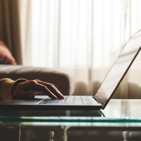 Person completing an online San Diego bail bonds application on a laptop from home for fast and convenient bail bond approval.