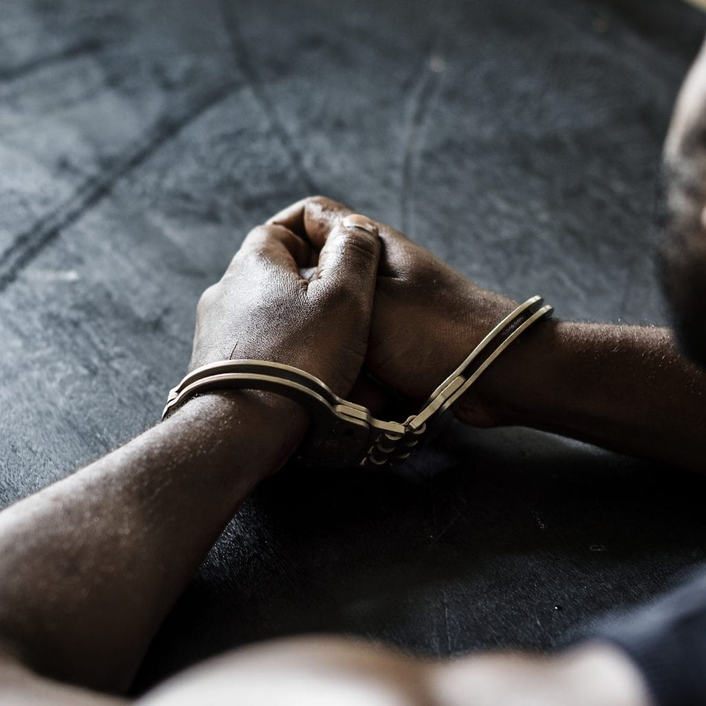 Arrested man in handcuffs representing the need for fast and reliable San Diego bail bonds services